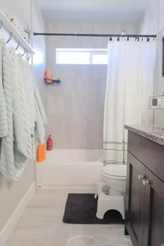White tub and shower combination with a horizontal window