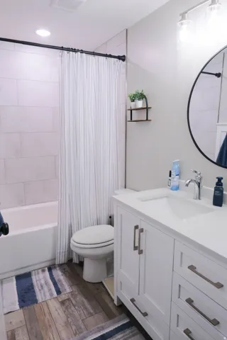 White vanity with brushed nickel hardware, integrated sink, and chrome faucet