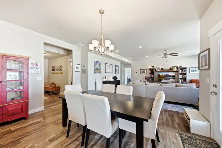 Open-concept living space with wood-finish flooring, recessed lighting, and a ceiling fan
