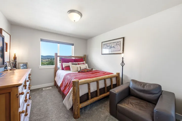 Carpeted room with a fixed window, flush mount ceiling light, and light-toned walls