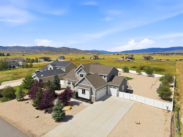 Contemporary-style home featuring a multi-gable roofline, attached garage, and a concrete driveway