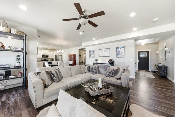 Spacious living area featuring wood-finish flooring, recessed lighting, and a ceiling fan