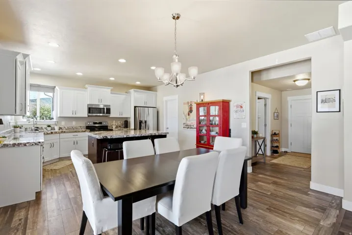 Open-concept kitchen and dining area with wood-finish flooring