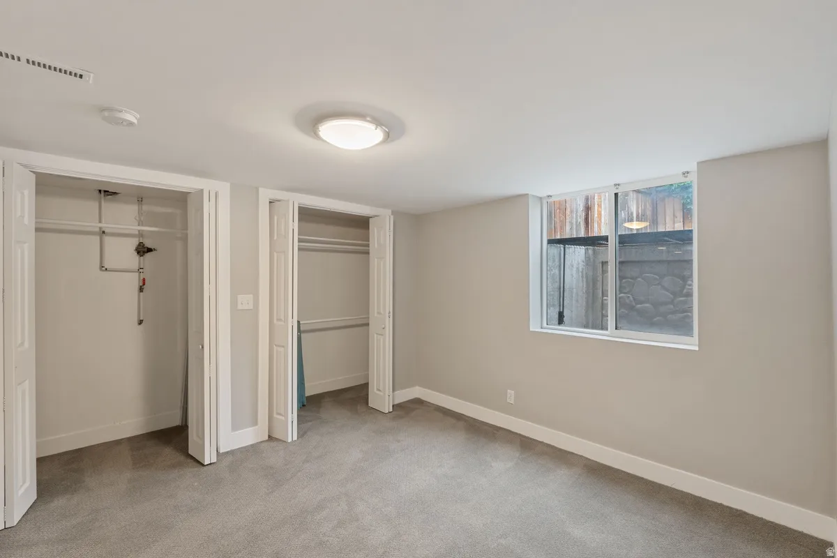Neutral wall color with white trim and carpet flooring