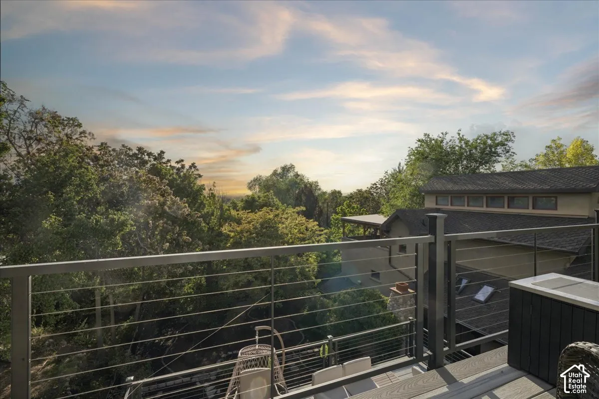 Expansive outdoor deck featuring composite wood-finish decking and a modern cable railing system