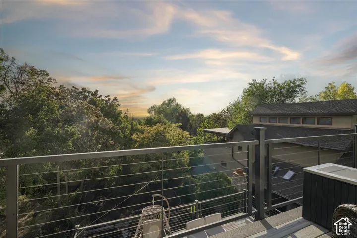 Expansive outdoor deck featuring composite wood-finish decking and a modern cable railing system