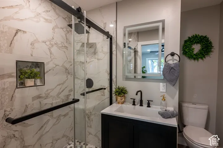 Walk-in shower with stone-look tile walls and a built-in niche