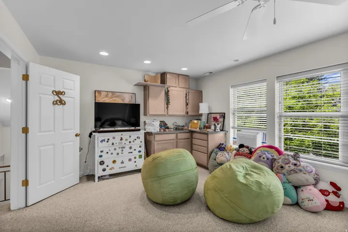 Recessed lighting, ceiling fan, and carpeted flooring