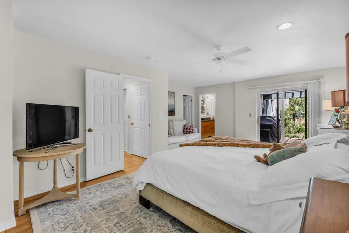 Recessed lighting, wood-finish flooring, white panel doors, ceiling fan, and sliding glass door to exterior