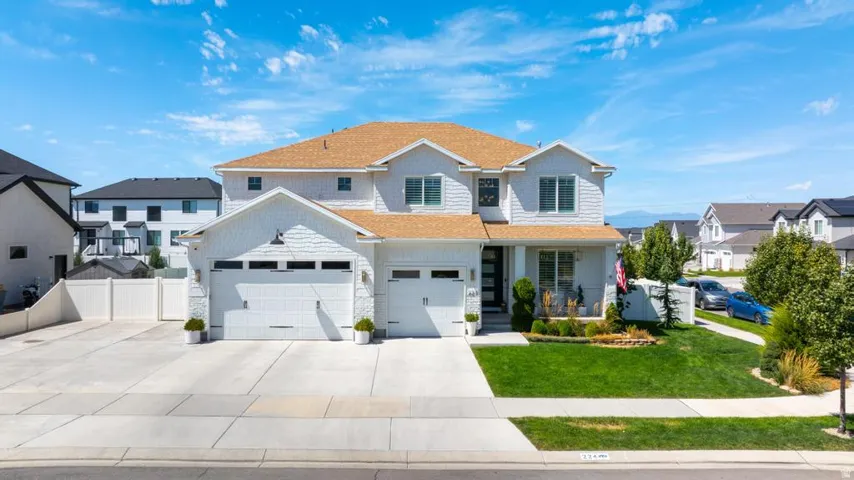 Impressive two-story residence featuring a clean, contemporary exterior with stone and siding accents