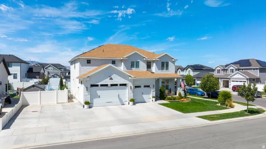 Two-story residence with a light-toned exterior siding and a multi-car garage
