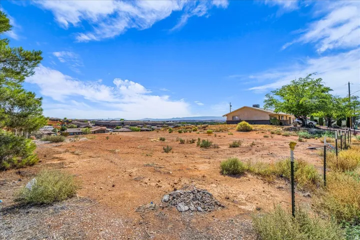 Expansive undeveloped parcel with a distant residential backdrop