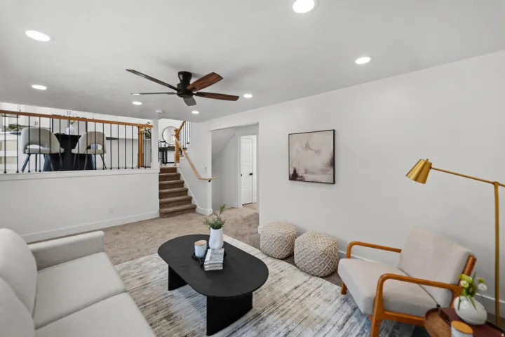 Open-concept living area with recessed lighting and a ceiling fan