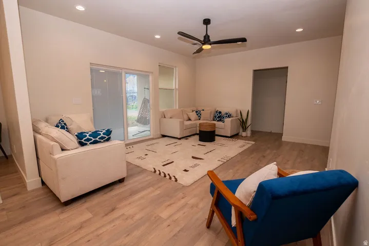 Recessed lighting, wood-finish flooring, ceiling fan, and sliding glass door