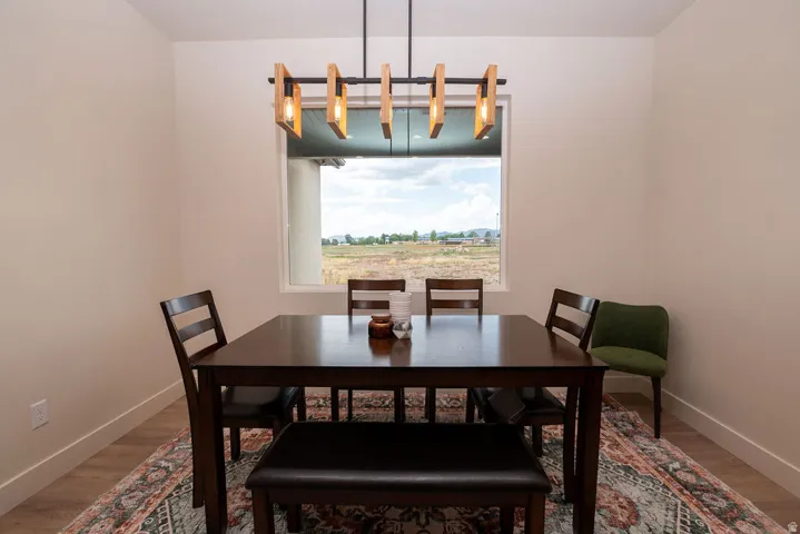 Window with outdoor scenery, recessed lighting, and wood-finish flooring