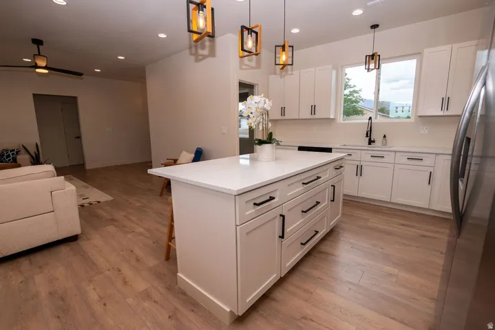Kitchen island with a white countertop and dark hardware