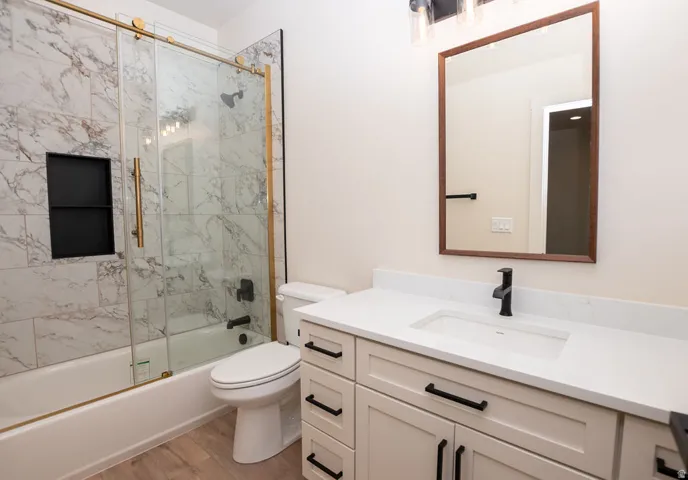 White vanity with integrated sink, white countertop, and matte black faucet