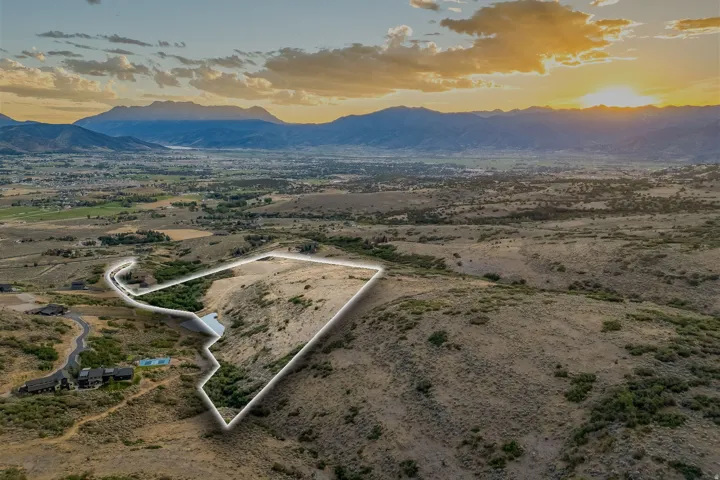 Expansive undeveloped lot with diverse topography and distant mountain scenery