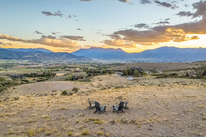 Expansive rural landscape with distant mountain ranges and a settlement