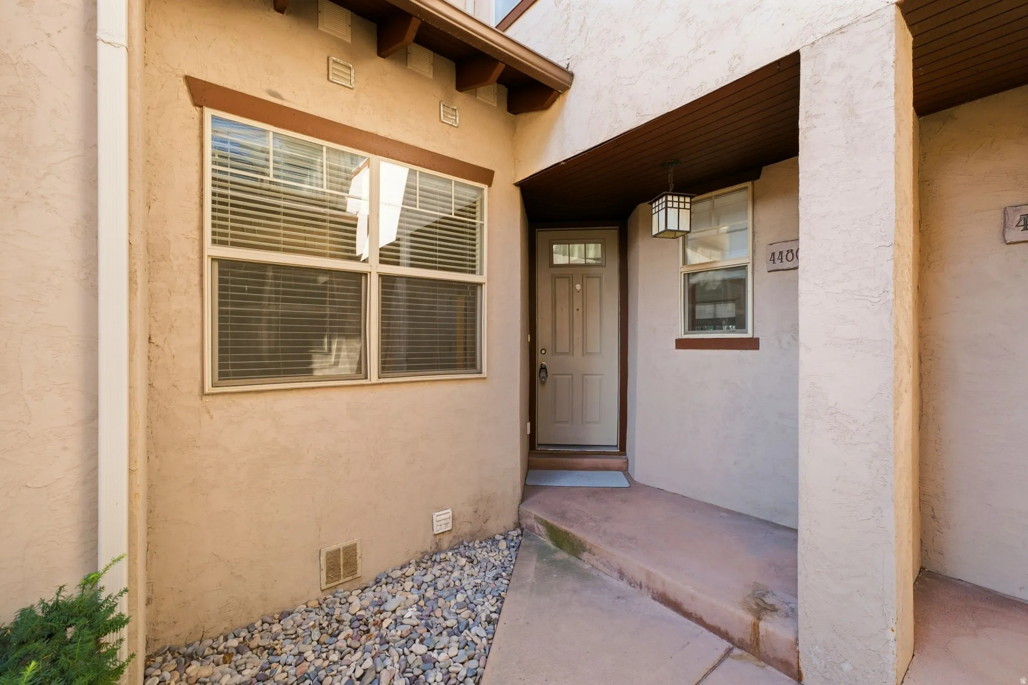 Stucco exterior with wood trim accents