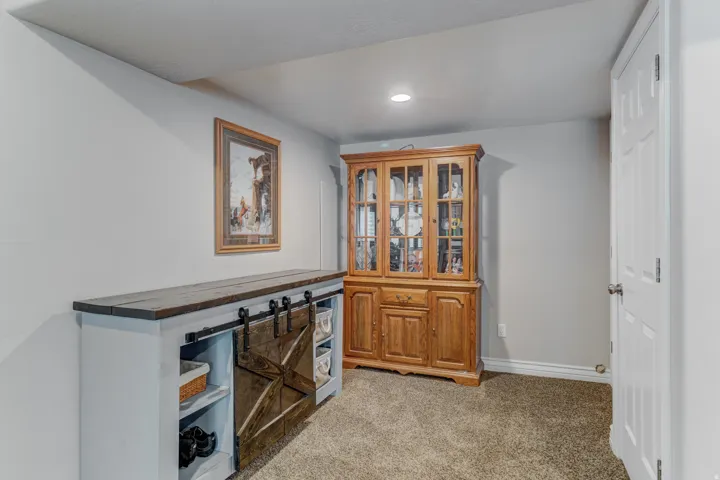 Interior space featuring light gray walls and brown carpet flooring