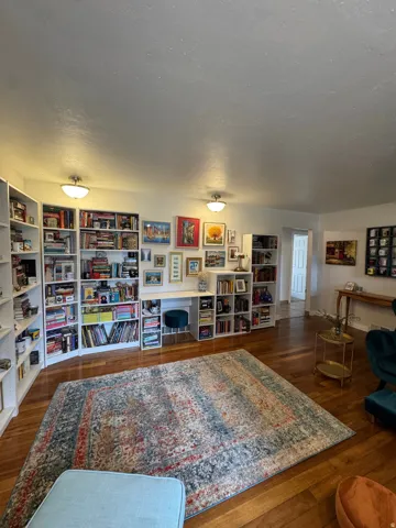 Hardwood-finish flooring, built-in shelving, recessed lighting, and a built-in desk area