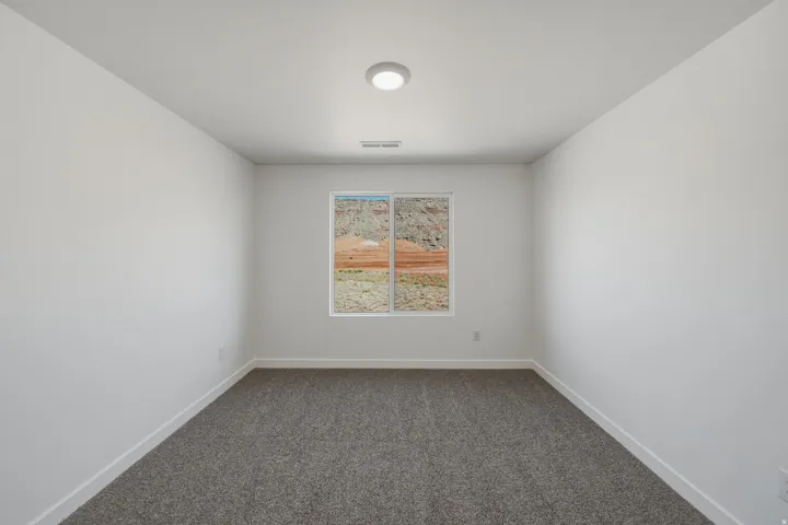 Recessed lighting, wall-to-wall carpeting, and a window with a mountain backdrop