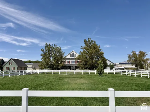 Expansive green lawn with white fencing