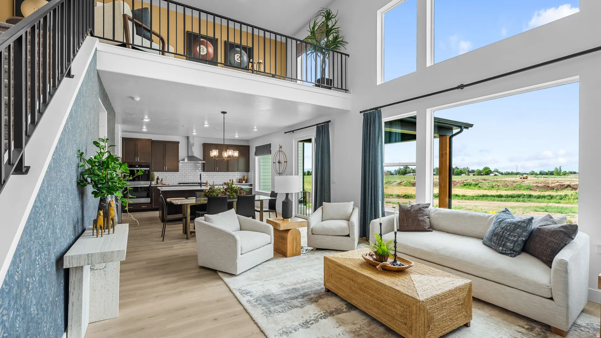 Two-story living area with high ceilings, upper-level railing, and expansive windows