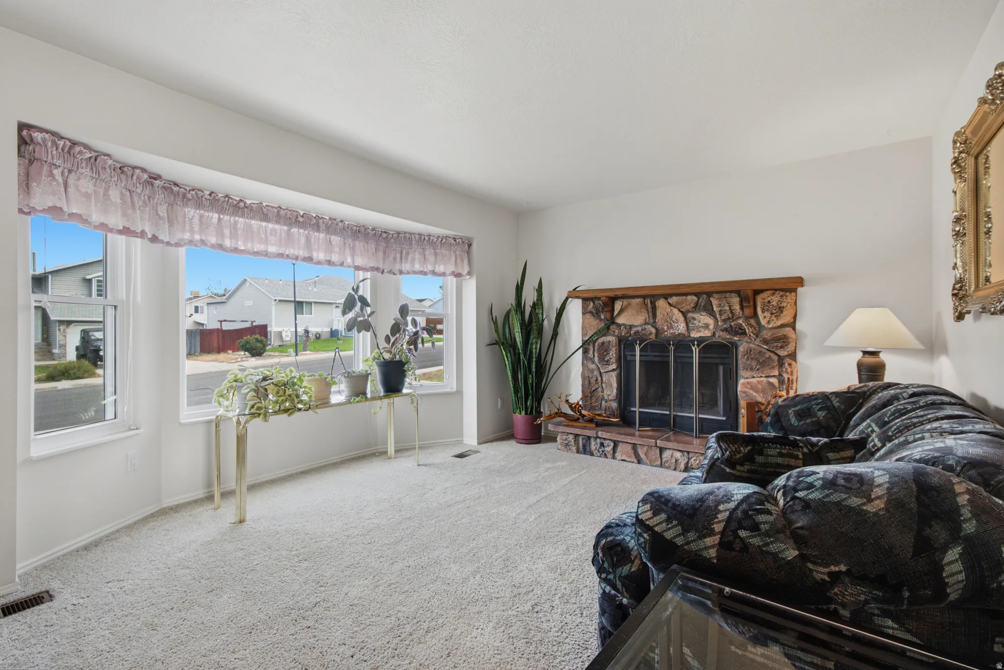 Bay window, fireplace with a wood mantel