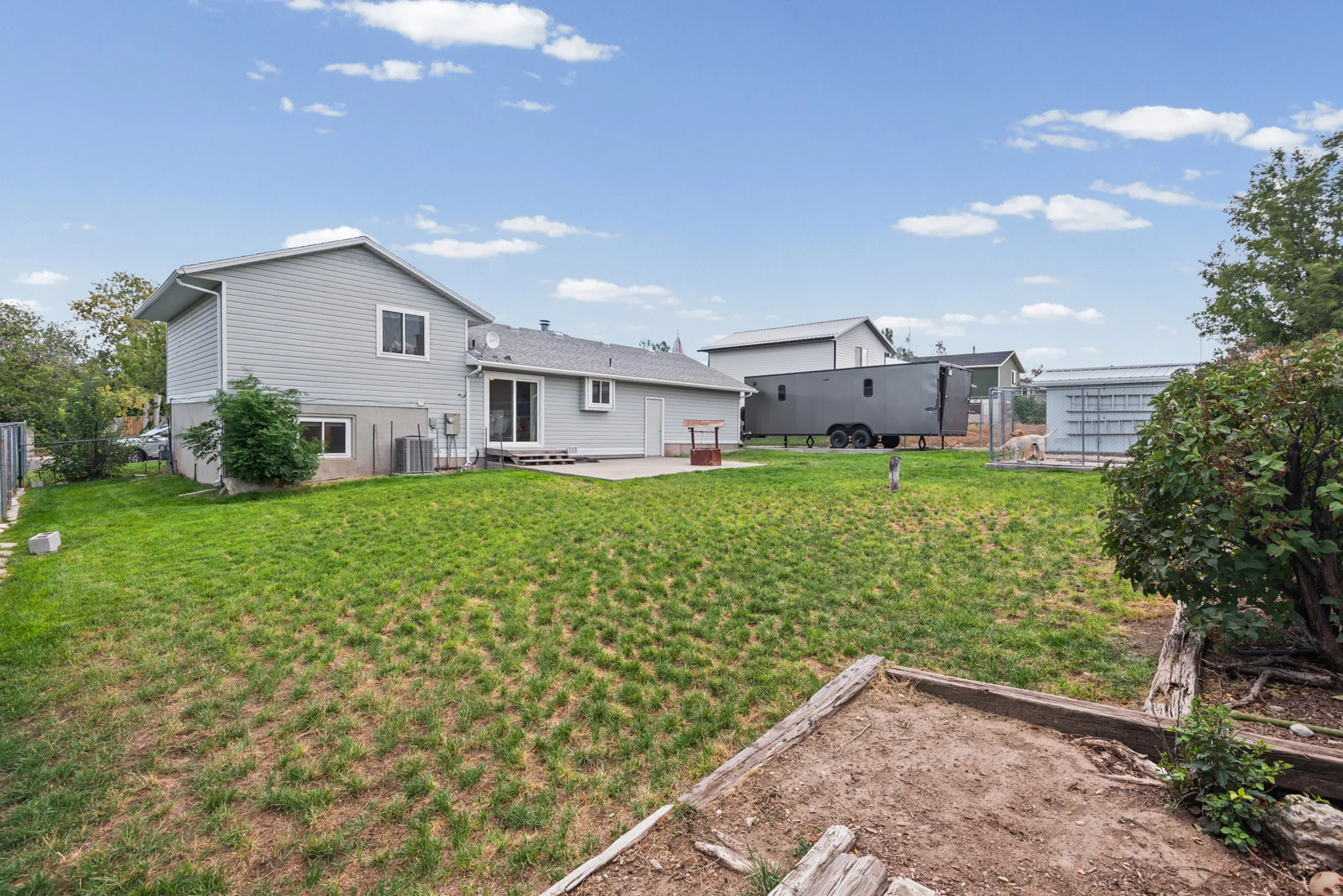Backyard features a concrete patio, sliding glass door access