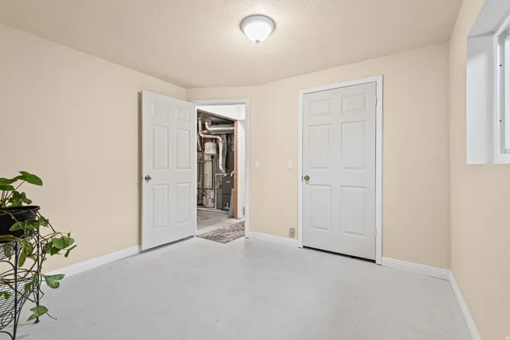 Neutral wall finishes, white trim, and a white six-panel door