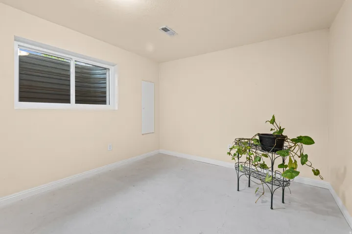 Recessed lighting and a single window with white trim