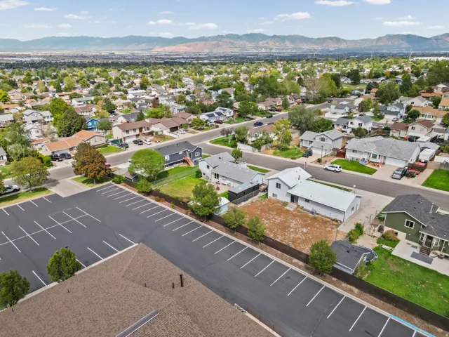 Residential neighborhood with established homes and mature landscaping, featuring paved streets and mountain scenery