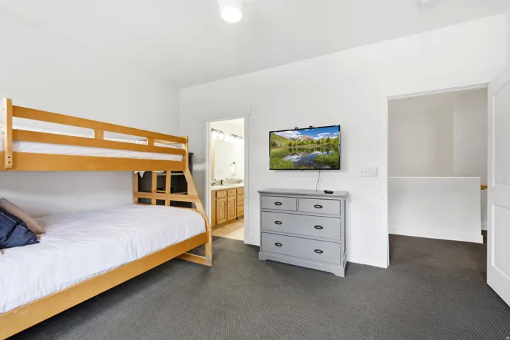 White walls with dark carpet flooring
