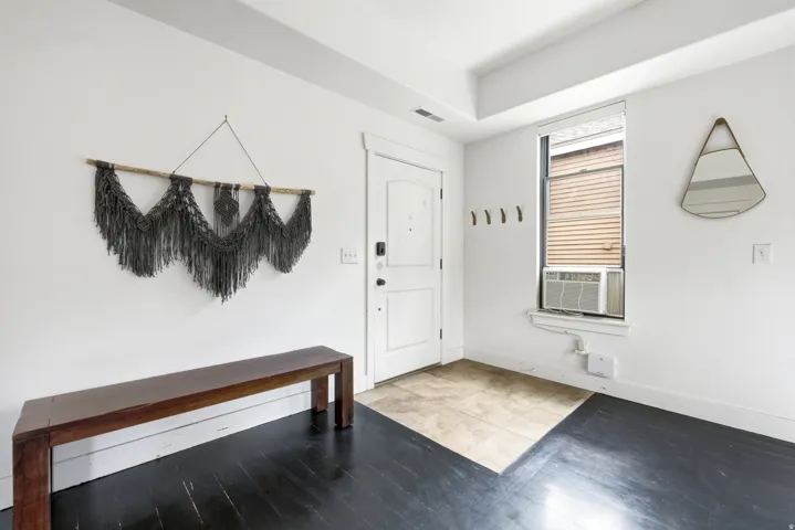 White painted walls with dark wood-finish flooring