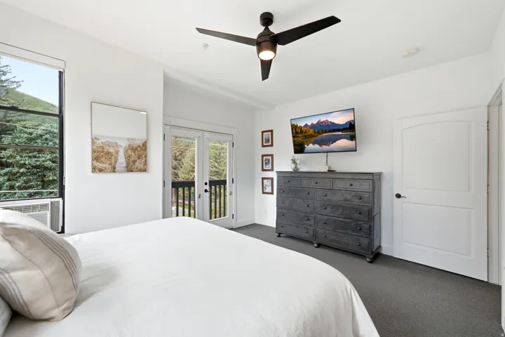 White walls with dark gray carpet flooring