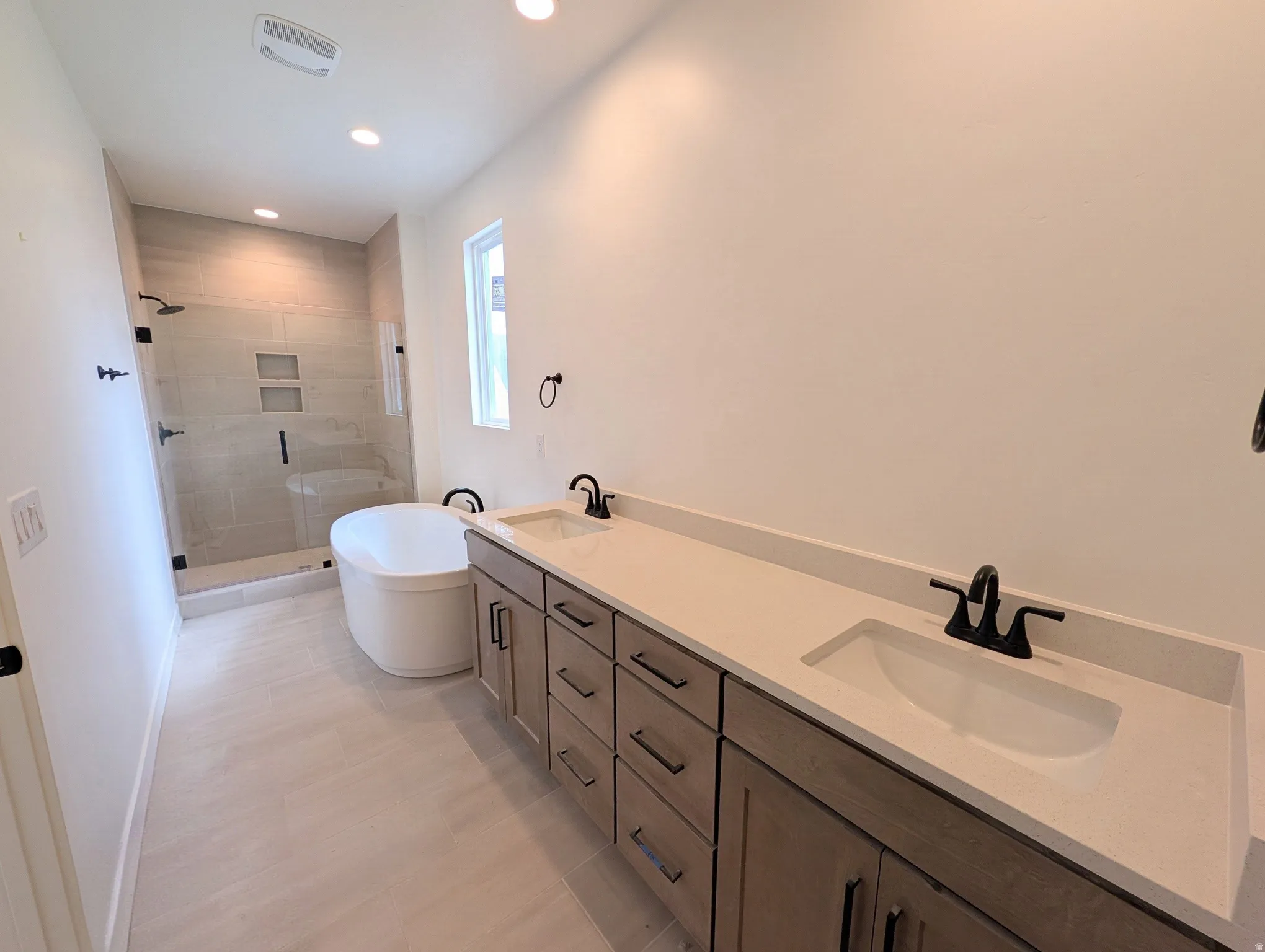 Dual vanity with rectangular undermount sinks and light-toned countertops