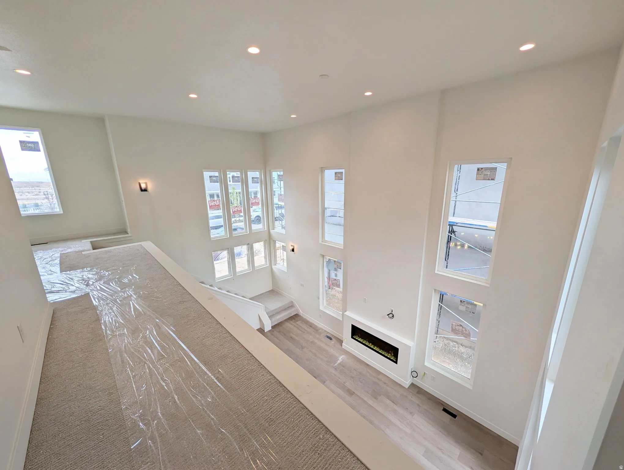 Two-story ceilings, recessed lighting, and multiple large windows