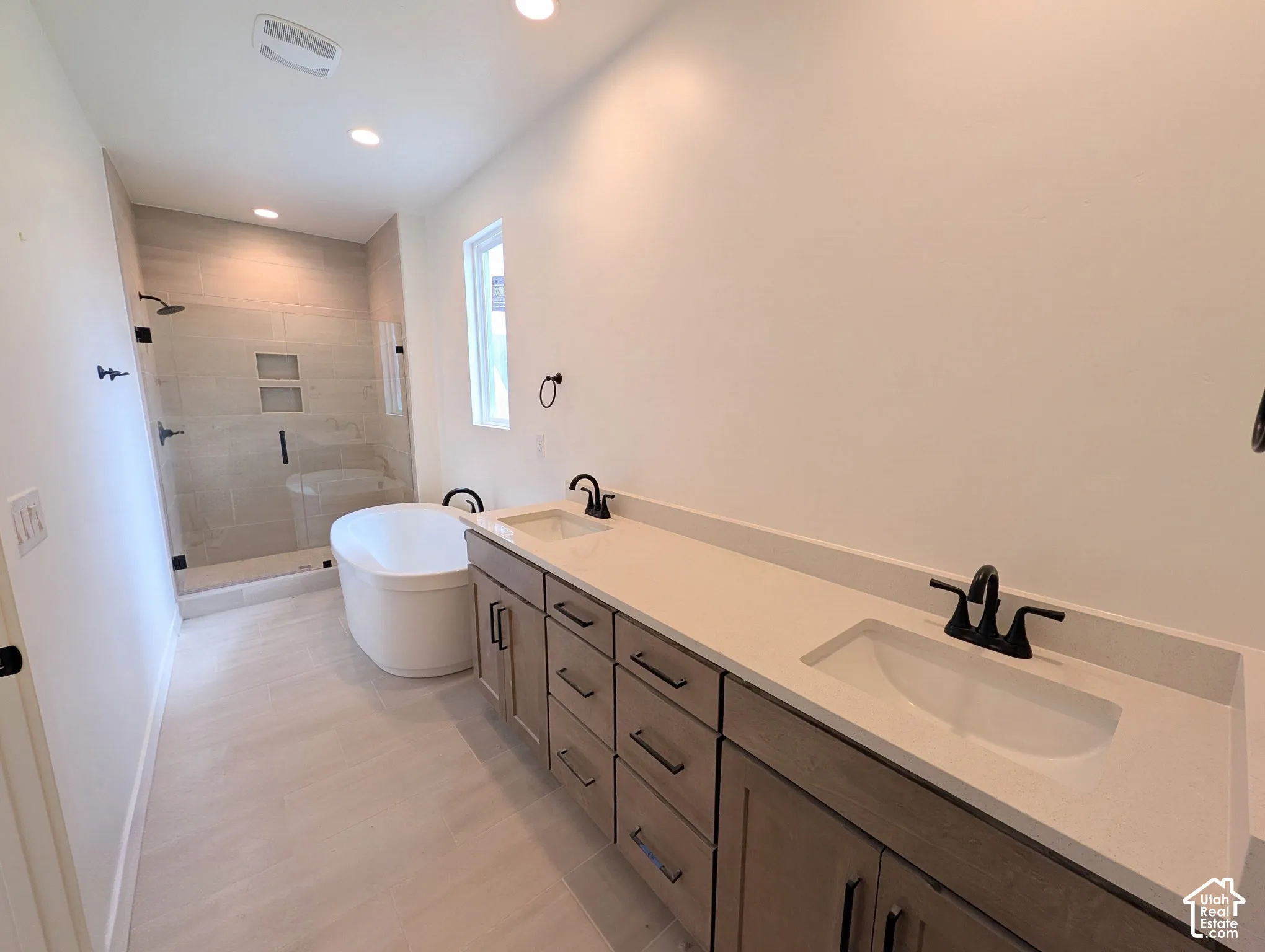 Dual vanity with rectangular undermount sinks and light-toned countertops