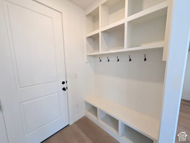 Built-in cubbies and shelving, integrated bench seating, and five wall-mounted hooks