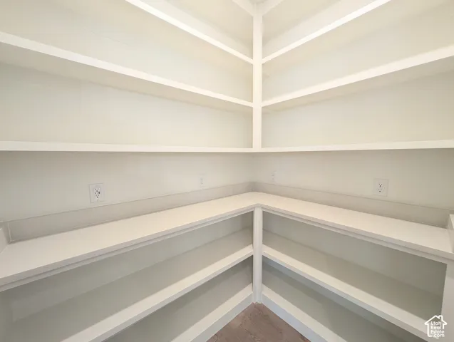 Built-in shelving with multiple levels, corner countertop, and integrated electrical outlets