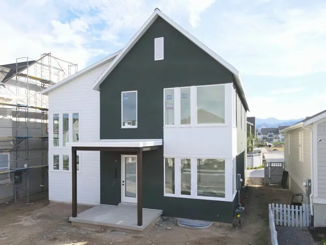 Modern exterior with dark-toned siding and white trim