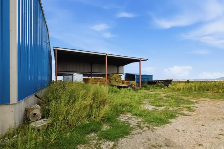 Corrugated metal siding structure with a concrete foundation