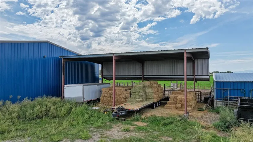 Blue corrugated metal building with an attached covered structure