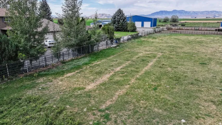 Expansive grassy parcel with mountain backdrop