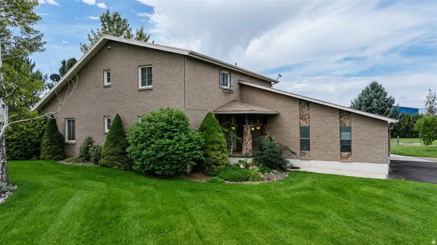 Brick exterior with stone accents and a low-pitch roof