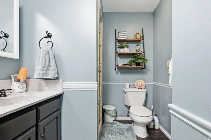 Vanity with a light-colored countertop, dark cabinetry, and dark hardware