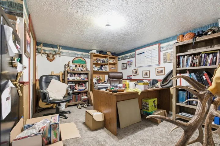 Recessed lighting illuminates the room with textured ceiling