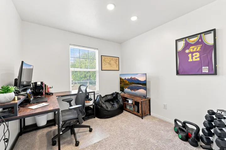 Neutral wall finishes, recessed lighting, and a single window with blinds